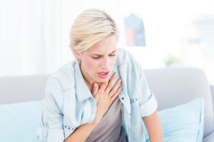 Pretty blonde woman having breath difficulties